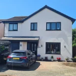 a house with new pvc windows, a composite door, and a new garage installed