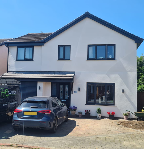 a house with new pvc windows, a composite door, and a new garage installed