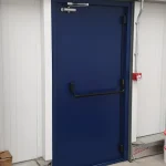 A dark Blue fire exit door equipped with a black horizontal push bar