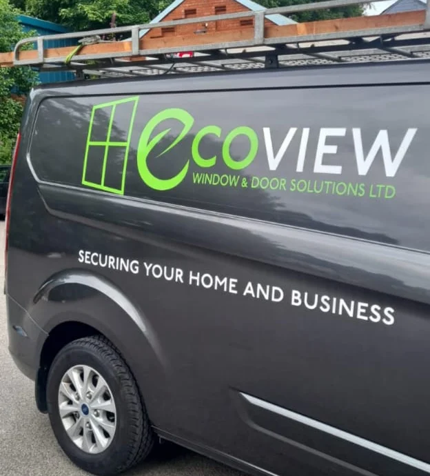 a dark grey van with a ladder on top and the ecoview logo on the side